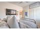 Bedroom featuring large bed, ceiling fan, and a television mounted on the wall at 5755 E La Campana Dr, Pahrump, NV 89061