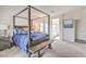 Comfortable bedroom featuring a canopy bed, soft carpet, and ensuite bathroom with a glass shower at 5755 E La Campana Dr, Pahrump, NV 89061