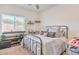 Bedroom features a metal bed frame and a large window at 5755 E La Campana Dr, Pahrump, NV 89061