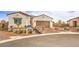 Charming single-story home featuring a brick driveway, stone accents, and a two-car garage at 5755 E La Campana Dr, Pahrump, NV 89061
