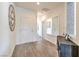 Inviting hallway with wood flooring, a decorative clock, and a modern accent table at 5755 E La Campana Dr, Pahrump, NV 89061