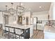 Modern kitchen with an oversized island, stylish pendant lights, and stainless steel appliances at 5755 E La Campana Dr, Pahrump, NV 89061