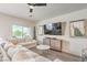 Bright living room features a comfortable sectional couch, modern ceiling fan and stylish decor at 5755 E La Campana Dr, Pahrump, NV 89061