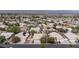 Expansive aerial view of a neighborhood featuring single-story homes with well-maintained landscaping and varied roof styles at 6032 Port Of Dreams Dr, Las Vegas, NV 89130