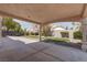 Spacious backyard with well-maintained lawn, mature trees, and a covered patio, ideal for outdoor activities at 6032 Port Of Dreams Dr, Las Vegas, NV 89130