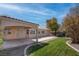 The expansive backyard features a covered patio, lush lawn, and meticulous landscaping for outdoor living and entertaining at 6032 Port Of Dreams Dr, Las Vegas, NV 89130