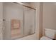 This bathroom includes a glass-enclosed shower with beige tile and a standard toilet at 6032 Port Of Dreams Dr, Las Vegas, NV 89130