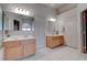 Bathroom featuring double sinks, white countertops, and a glass-enclosed shower at 6032 Port Of Dreams Dr, Las Vegas, NV 89130