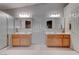 Bathroom with double sinks, tile flooring, and a glass enclosed shower at 6032 Port Of Dreams Dr, Las Vegas, NV 89130
