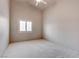 This bedroom features neutral walls, a ceiling fan, carpet, and a window providing lots of natural light at 6032 Port Of Dreams Dr, Las Vegas, NV 89130