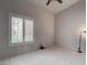 Bedroom with shuttered window, neutral walls, tile flooring, and ample natural light at 6032 Port Of Dreams Dr, Las Vegas, NV 89130
