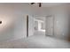 Bedroom with arched doorway, neutral walls, tile flooring, and white doors at 6032 Port Of Dreams Dr, Las Vegas, NV 89130