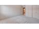 Neutral bedroom with carpet, double closet doors, and an open doorway to another room at 6032 Port Of Dreams Dr, Las Vegas, NV 89130