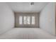 Bright bedroom featuring neutral paint, a large window, and carpeted floor at 6032 Port Of Dreams Dr, Las Vegas, NV 89130