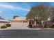 Charming single-story home featuring a neutral color palette, mature trees, and a two-car garage at 6032 Port Of Dreams Dr, Las Vegas, NV 89130