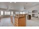Kitchen with granite countertop island that flows to the living room and fireplace at 6032 Port Of Dreams Dr, Las Vegas, NV 89130