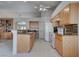 Spacious kitchen with granite countertops, island with sink, and is connected to the built-in bookcase and main living areas at 6032 Port Of Dreams Dr, Las Vegas, NV 89130