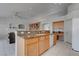 Kitchen features a convenient island with bar seating, connecting seamlessly to the adjacent living spaces and built-in bookcases at 6032 Port Of Dreams Dr, Las Vegas, NV 89130