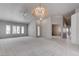 Bright living room featuring neutral paint, a large window, and carpeted floor at 6032 Port Of Dreams Dr, Las Vegas, NV 89130