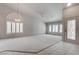 Bright living room featuring neutral paint, a large window, carpeted floor, and modern lighting at 6032 Port Of Dreams Dr, Las Vegas, NV 89130