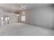 Bright living room featuring neutral paint, archways, and carpeted floor at 6032 Port Of Dreams Dr, Las Vegas, NV 89130
