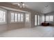 Bright living room with tiled flooring, shuttered windows, and a ceiling fan at 6032 Port Of Dreams Dr, Las Vegas, NV 89130