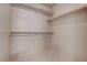 Bright walk-in closet offering ample storage and organization with multiple shelves and tile floors at 6032 Port Of Dreams Dr, Las Vegas, NV 89130