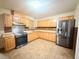 Traditional kitchen with stainless steel appliances and light wood cabinets at 6248 Dayton Ave, Las Vegas, NV 89107