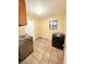 This laundry room features tile flooring and modern washer and dryer machines at 6248 Dayton Ave, Las Vegas, NV 89107