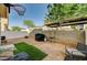 Backyard with block wall, gravel, grassy areas, and patio space for entertainment at 6404 Extreme Shear Ave # 103, Henderson, NV 89011