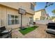 Backyard with block wall, gravel, grassy areas, and patio space for entertainment at 6404 Extreme Shear Ave # 103, Henderson, NV 89011