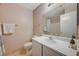 Neutral bathroom featuring a white vanity, tile flooring, and a shower-tub combo at 6404 Extreme Shear Ave # 103, Henderson, NV 89011