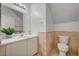 Bathroom features a white vanity, a sink and marble style wall tiles at 6404 Extreme Shear Ave # 103, Henderson, NV 89011