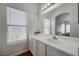 Bright bathroom features a large mirror, bright window, and a well-lit vanity at 6404 Extreme Shear Ave # 103, Henderson, NV 89011