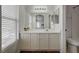 Bright bathroom with a large mirror, white cabinets, and convenient sink vanity at 6404 Extreme Shear Ave # 103, Henderson, NV 89011