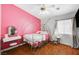 Adorable bedroom with decorative bedframe, a large window, and hardwood floors at 6404 Extreme Shear Ave # 103, Henderson, NV 89011