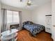 Bright bedroom with themed bedding, wood floors and ceiling fan at 6404 Extreme Shear Ave # 103, Henderson, NV 89011