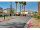 Gated community entrance with palm trees, attractive landscaping, and secure access for residents' peace of mind at 6404 Extreme Shear Ave # 103, Henderson, NV 89011