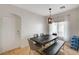 Bright dining area featuring contemporary light fixture and an elegant dark wood table at 6404 Extreme Shear Ave # 103, Henderson, NV 89011