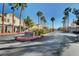 Community entrance featuring lush palm trees, manicured landscaping, and an inviting gated entrance at 6404 Extreme Shear Ave # 103, Henderson, NV 89011