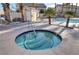 Community hot tub surrounded by palm trees, offering a relaxing and resort-like amenity for residents at 6404 Extreme Shear Ave # 103, Henderson, NV 89011