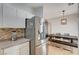 Open kitchen design with stainless steel refrigerator and a view into the dining area at 6404 Extreme Shear Ave # 103, Henderson, NV 89011