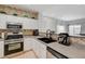 A spacious kitchen with stainless steel appliances, black sink and decorative backsplash at 6404 Extreme Shear Ave # 103, Henderson, NV 89011