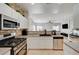 Modern kitchen features stainless appliances and white cabinetry at 6404 Extreme Shear Ave # 103, Henderson, NV 89011