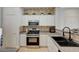 Well-lit kitchen featuring stainless steel appliances, white cabinets and decorative backsplash at 6404 Extreme Shear Ave # 103, Henderson, NV 89011