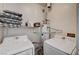 Functional laundry area equipped with a washer, dryer, and shelving at 6404 Extreme Shear Ave # 103, Henderson, NV 89011