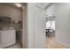 Functional laundry area equipped with a washer, dryer, and shelving near dining area at 6404 Extreme Shear Ave # 103, Henderson, NV 89011