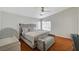 Bedroom featuring wood floor, ceiling fan and plenty of natural light at 6404 Extreme Shear Ave # 103, Henderson, NV 89011