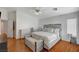 Bright main bedroom showcasing wood floors, modern furnishings, and a tranquil atmosphere at 6404 Extreme Shear Ave # 103, Henderson, NV 89011