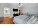 Spacious main bedroom with wood floors, large television, and ensuite bathroom entrance at 6404 Extreme Shear Ave # 103, Henderson, NV 89011